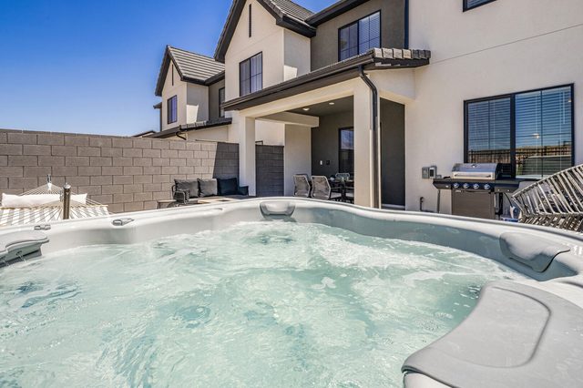 Private hot tub with house and grill behind at Skyline 1682