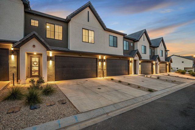 Front exterior and garage of Skyline 1686 at dusk