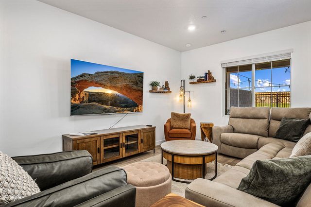 Living room sectional and leather sofa facing a large TV
