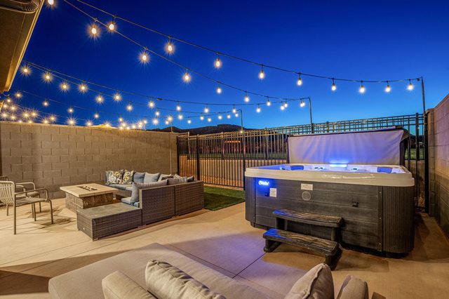 Private seven-person hot tub glowing blue at night