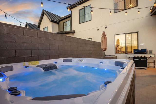 Private hot tub with grill and house behind