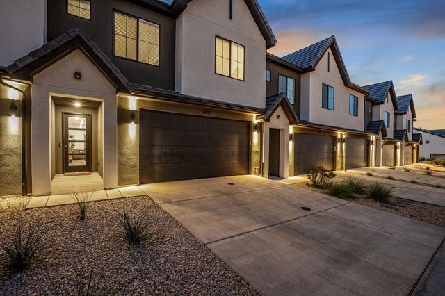 Skyline 1690 front entry and garage lit at dusk