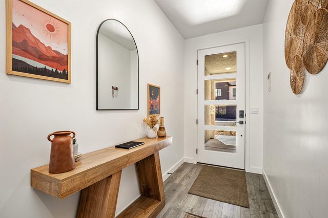 Front entry with arched mirror and wood console table