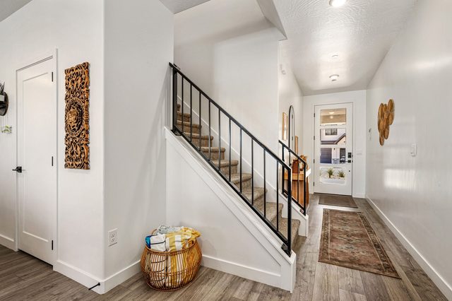Main floor hallway with staircase to the upstairs loft