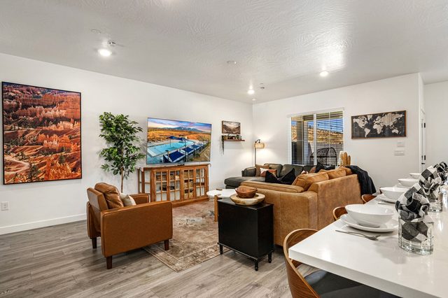 Living room seating around a round coffee table and smart TV