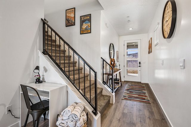 Front entry with staircase and downstairs desk area