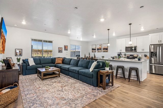 Open great room with blue sectional and kitchen island