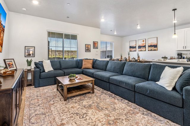 Oversized blue sectional around a wood coffee table