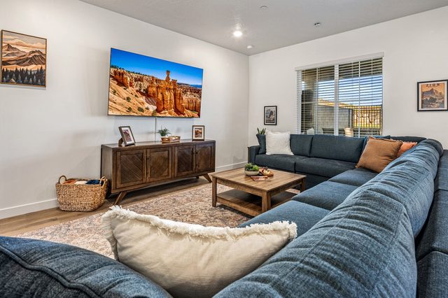 Living room smart TV above a wood media console