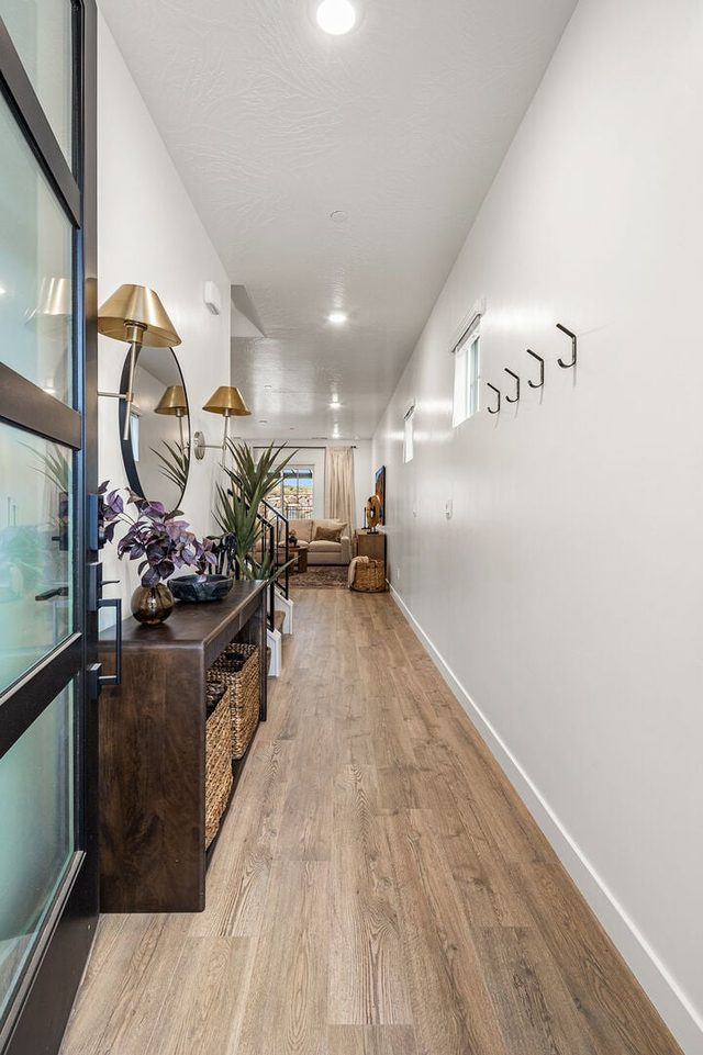 Entry hallway with console table and wall hooks at Skyline 1698