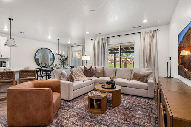 Living room sectional and leather chair beside the kitchen island