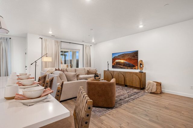 Living room with sectional sofa and wall-mounted TV over console