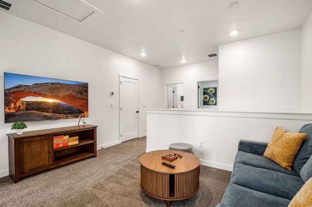 Upstairs loft lounge with sectional sofa and wall-mounted TV