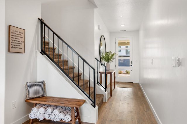 Front entry hall with staircase and bench to the upper floor