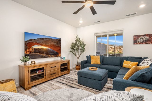 Sectional sofa facing a large TV in the main living room