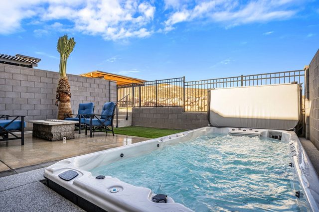Private heated swim spa beside the fire pit patio at Skyline 1710