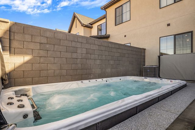 Swim spa along the back wall of the townhome yard