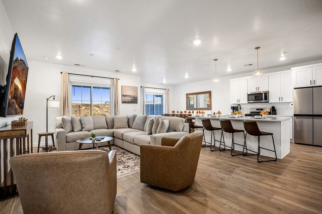 Open living room flowing into the kitchen island at Skyline 1714