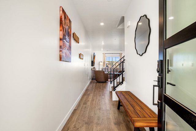 Front entry hallway with wood bench leading to the staircase