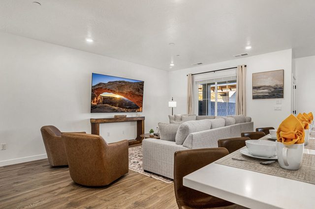Living area with leather swivel chairs and sectional seen from the dining table