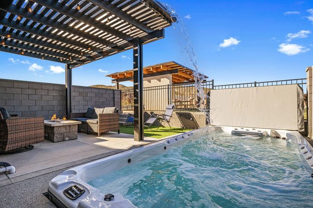 Private swim spa with waterfall feature beside the fire pit lounge at Skyline 1714