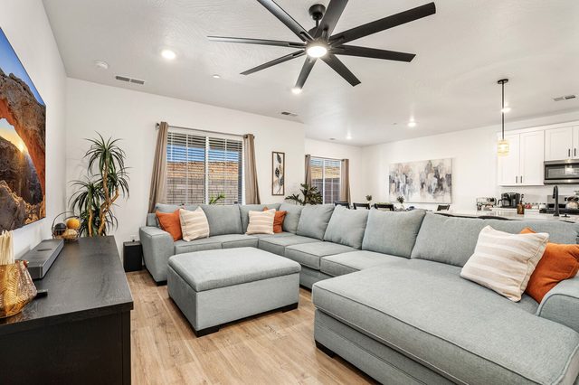 Living room with oversized sectional and ottoman at Skyline 1729