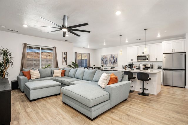 Open living room and kitchen with island seating at Skyline 1729