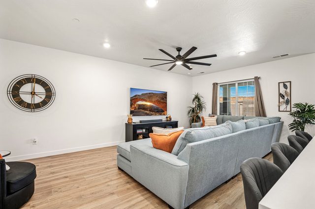 Living room sectional facing a large TV at Skyline 1729