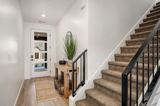 Front entry and carpeted staircase at Skyline 1737
