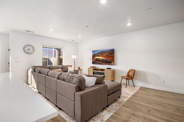 Great room sectional facing the TV and electric fireplace