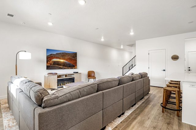 Oversized sectional sofa and staircase in the main living area