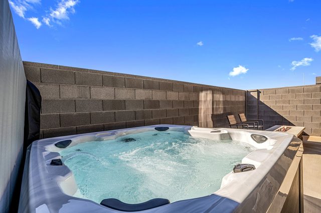 Private hot tub in the walled back patio