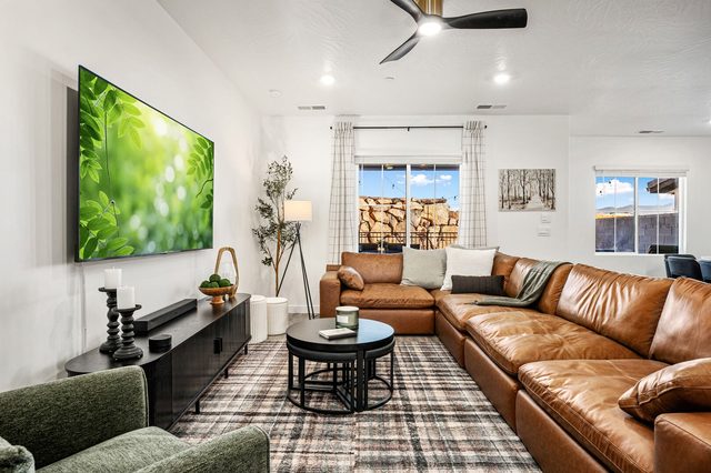 Living room with leather sectional and large smart TV