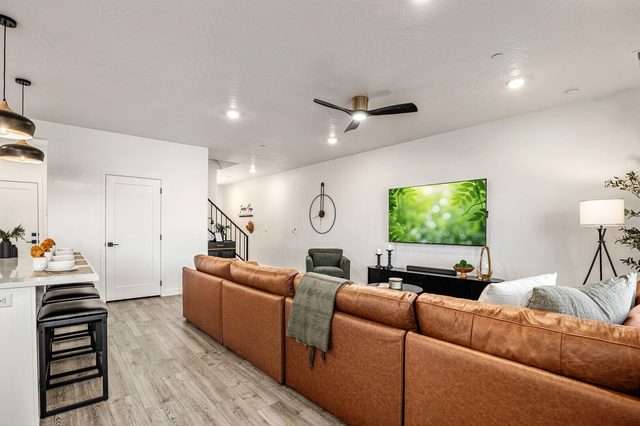 Living room sectional facing the TV beside the kitchen bar