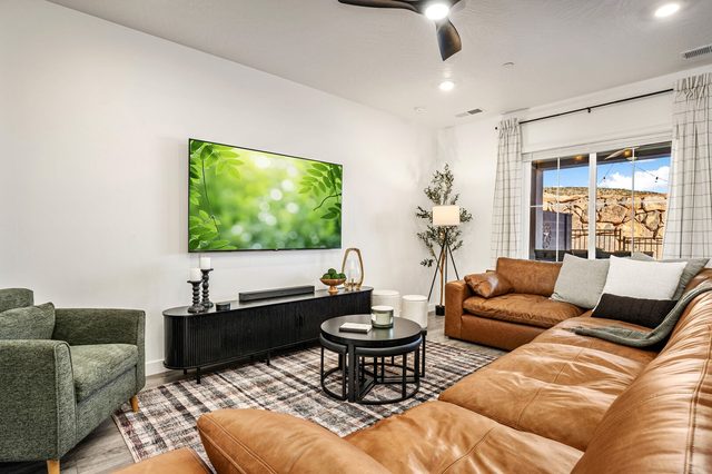 Living room seating area with sectional and green armchair