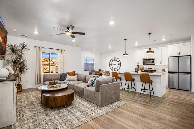 Open living room with sectional flowing into the kitchen