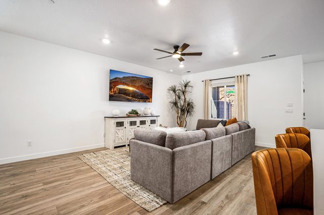 Living room sectional facing the TV and window