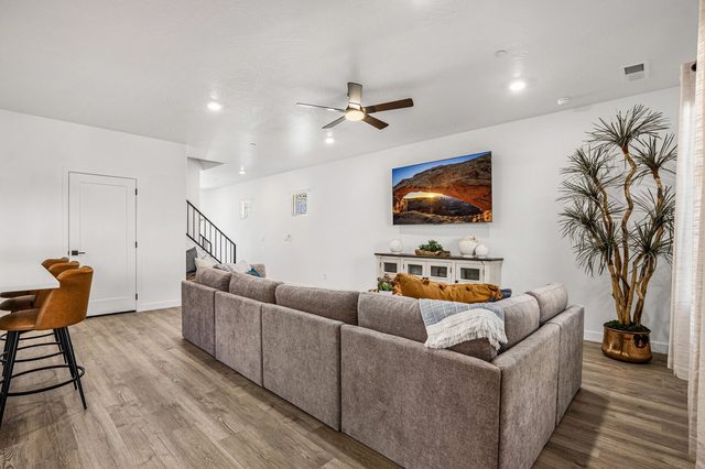 Living room sectional and staircase at Skyline 1742