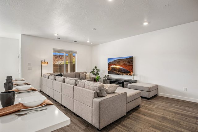 Living room sectional and TV viewed from the kitchen island