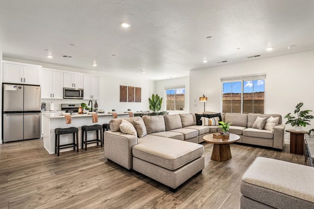 Open great room with sectional sofa and kitchen island seating