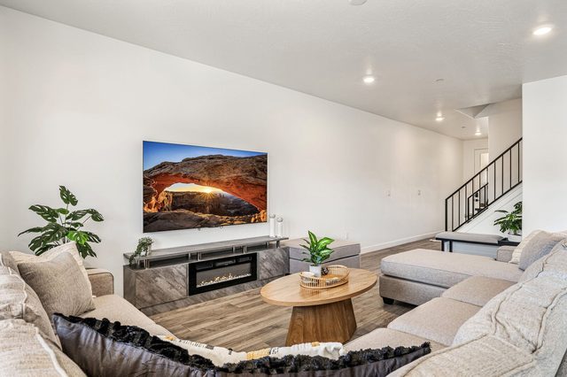 Living room sectional, round coffee table and wall-mounted TV
