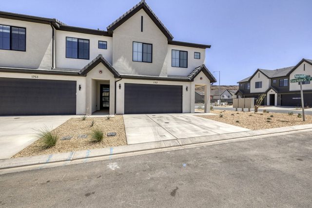 Street view of the two-story townhome and driveway