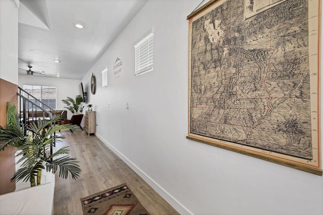 Main floor hallway with vintage wall map leading to the living area