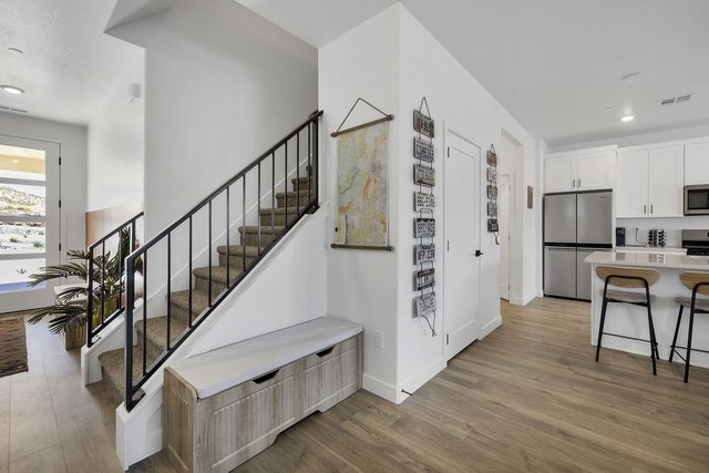 Staircase and entry bench opening to the kitchen at Skyline 1757