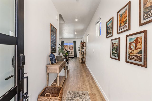 Front entry hallway with framed national park prints and wood floors