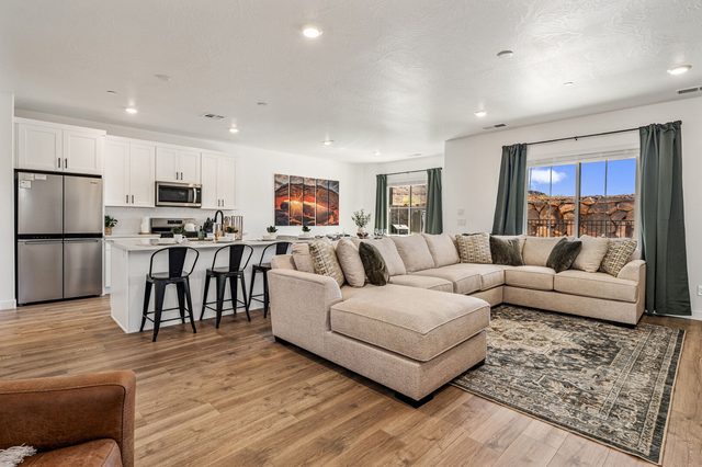Open living room sectional flowing into the kitchen at Skyline 2774