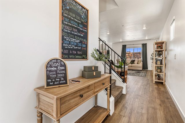 Entry console with chalkboard welcome sign and staircase beyond