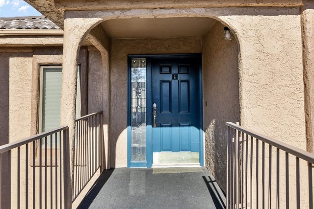 Front entry walkway and blue door at Sports Village X-8