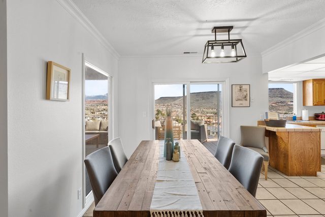 Long wood dining table with the kitchen counter beyond