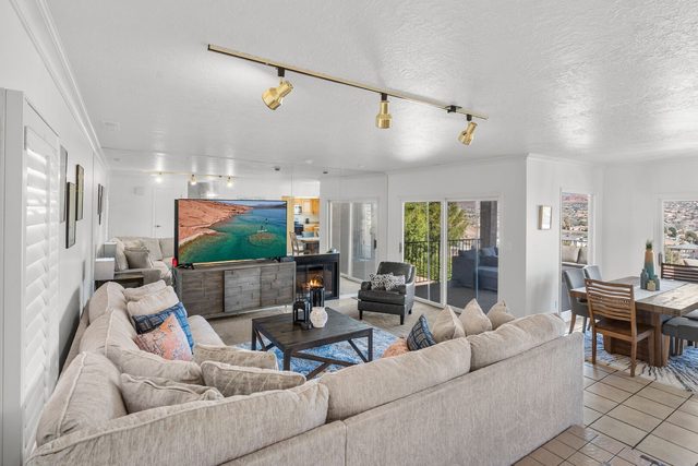 Living room with sectional sofa, fireplace and TV at Sports Village X-8